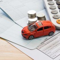 Image of a toy car on the paper used as paper holder, Auto Aid Collision, Auto Body Shop