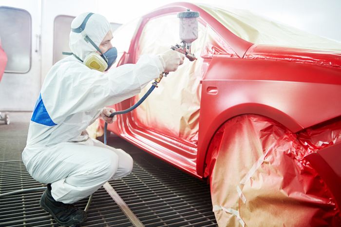 Image of a person painting the car, Auto Aid Collision, Auto Body Repair Process