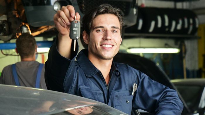 Image of a person handing over the key , Auto Aid Collision, Auto Body Repair Process