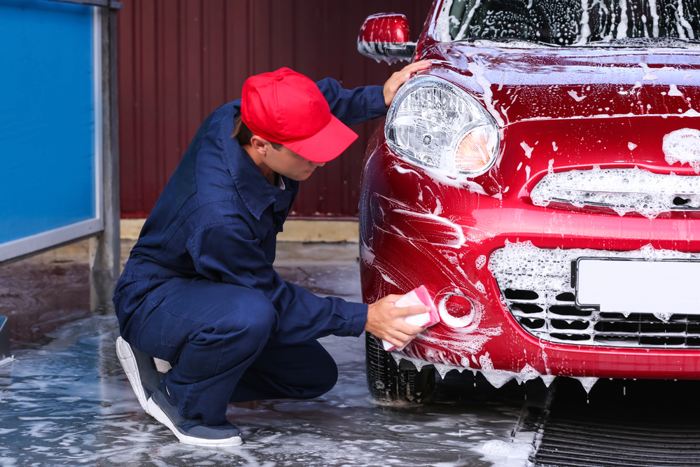 Image of a person washing the car, Auto Aid Collision, Auto Body Repair Process